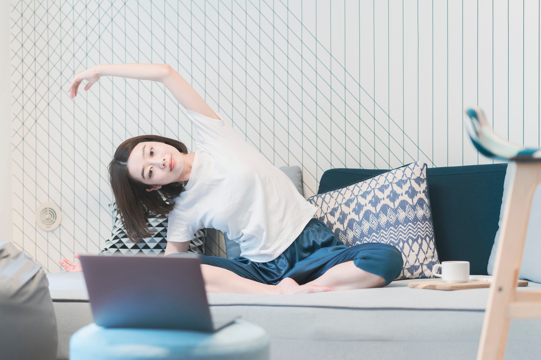 Woman taking an online yoga lesson