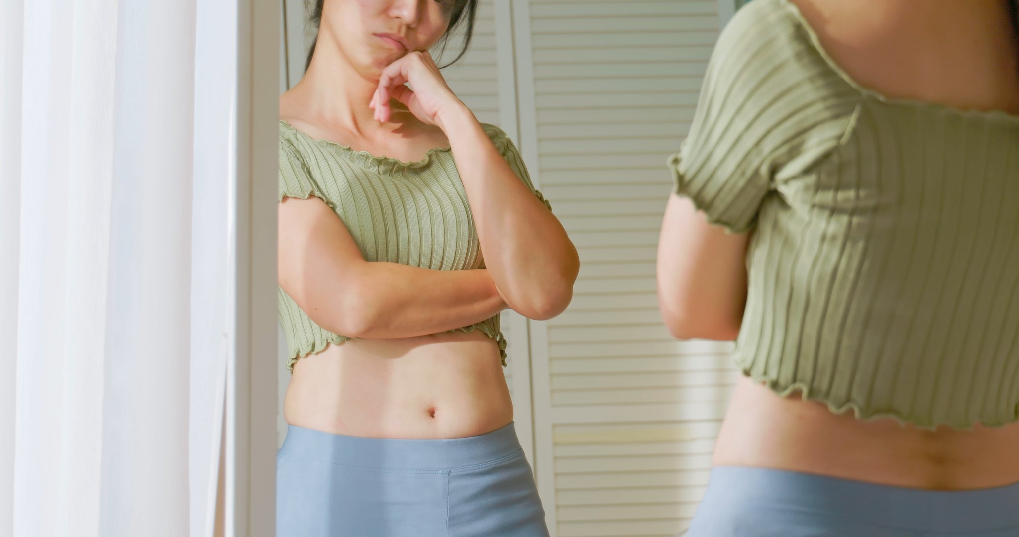 Disappointed Woman Looking at Herself on a Mirror